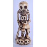 A 19TH CENTURY JAPANESE MEIJI PERIOD CARVED BONE MEMENTO MORI modelled as a skeleton. 7.5 cm high.