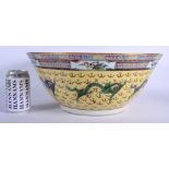 A LARGE EARLY 20TH CENTURY CHINESE FAMILLE JAUNE BOWL Qing/Republic, painted with dragons amongst cl