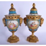 A PAIR OF 19TH CENTURY FRENCH SEVRES PORCELAIN VASES AND COVERS with gilt bronze fittings. 29 cm x 1