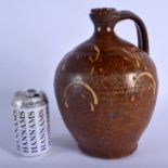 A 17TH/18TH CENTURY DUTCH SLIP GLAZED POTTERY ALE JUG decorated with swirls. 29 cm x 15 cm.