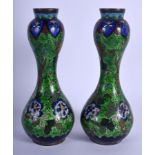 A PAIR OF LATE 19TH CENTURY JAPANESE MEIJI PERIOD CLOISONNÉ ENAMEL VASES decorated with figures. 20