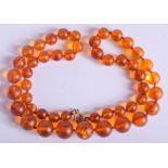 A 1930S AMBER NECKLACE. 24 grams. 48 cm long.