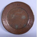 AN ARTS AND CRAFTS BEATEN COPPER DISH initialled AG. 24 cm wide.