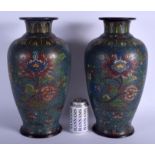 A LARGE PAIR OF 19TH CENTURY CHINESE CLOISONNÉ ENAMEL BRONZE VASES decorated with foliage and vines.