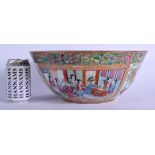 A LARGE 19TH CENTURY CHINESE CANTON FAMILLE ROSE PUNCH BOWL Qing, painted with figures within interi