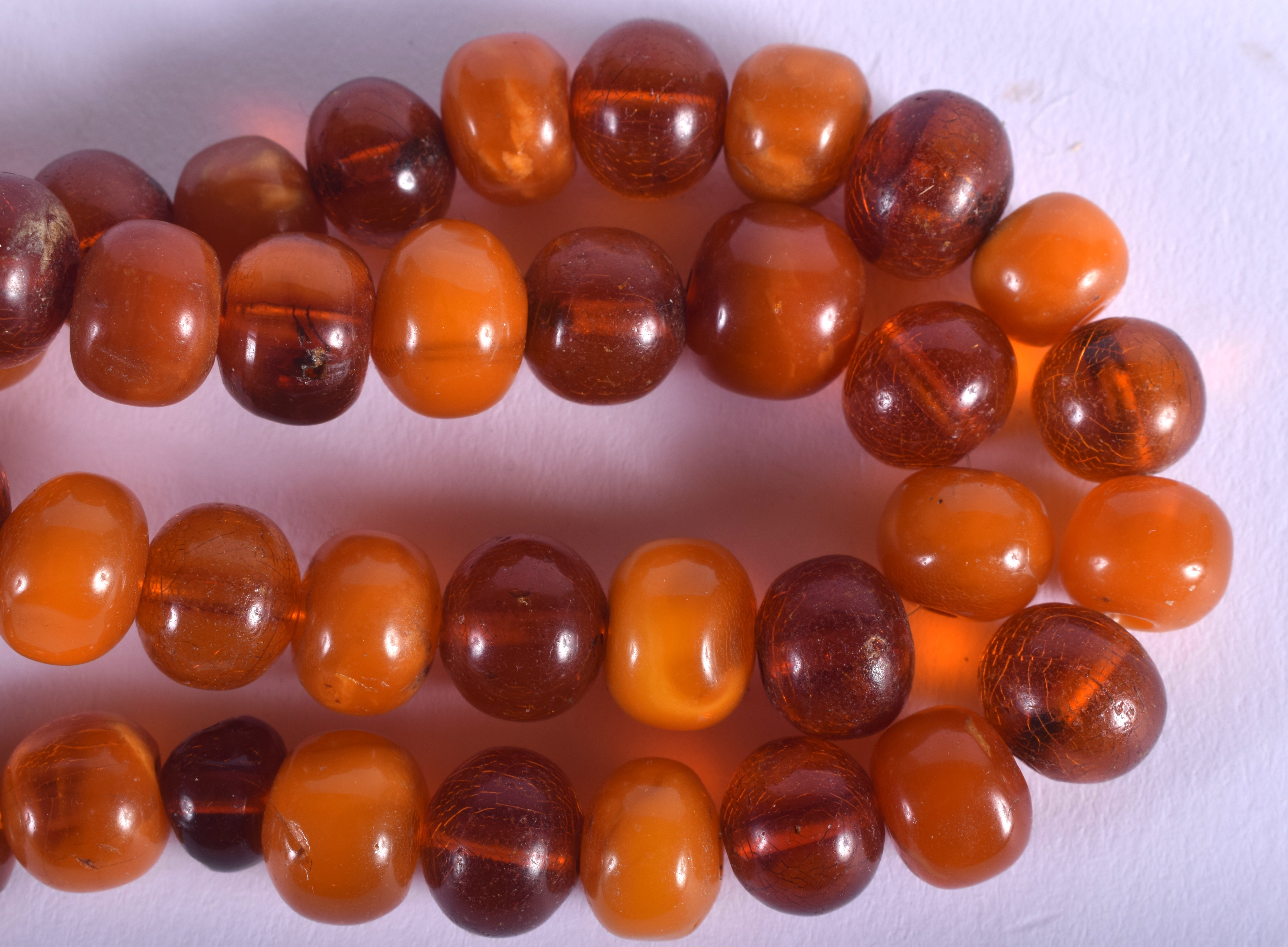 A 1930S ORANGE AND BUTTERSCOTCH AMBER NECKLACE of uni-form. 35 grams. 48 cm long, each bead 0.5 cm w - Image 2 of 3