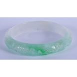 A CHINESE CARVED JADEITE BANGLE 20th Century. 7 cm diameter.