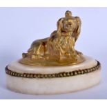 AN EARLY 19TH CENTURY ENGLISH ORMOLU FIGURE OF A SPANIEL upon a marble base. 11 cm wide.