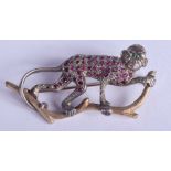 A VERY RARE ANTIQUE GOLD SILVER RUBY AND EMERALD BROOCH in the form of a monkey. 12,8 grams. 5 cm x