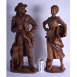 A VERY LARGE PAIR OF EARLY 20TH CENTURY BAVARIAN BLACK FOREST FIGURES modelled as a male and female.