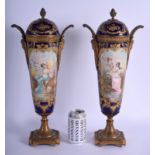 A LARGE PAIR OF 19TH CENTURY FRENCH SEVRES PORCELAIN VASES AND COVERS painted with romantic scenes a