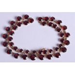 AN ANTIQUE GOLD MOUNTED GARNET NECKLACE. 31.4 grams. 4.4 cm x 0.6 cm, largest garnet 0.6 cm x 0.6 cm