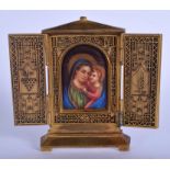 A 19TH CENTURY EUROPEAN BRONZE AND PORCELAIN FOLDING ICON painted with a view of Madonna and child.