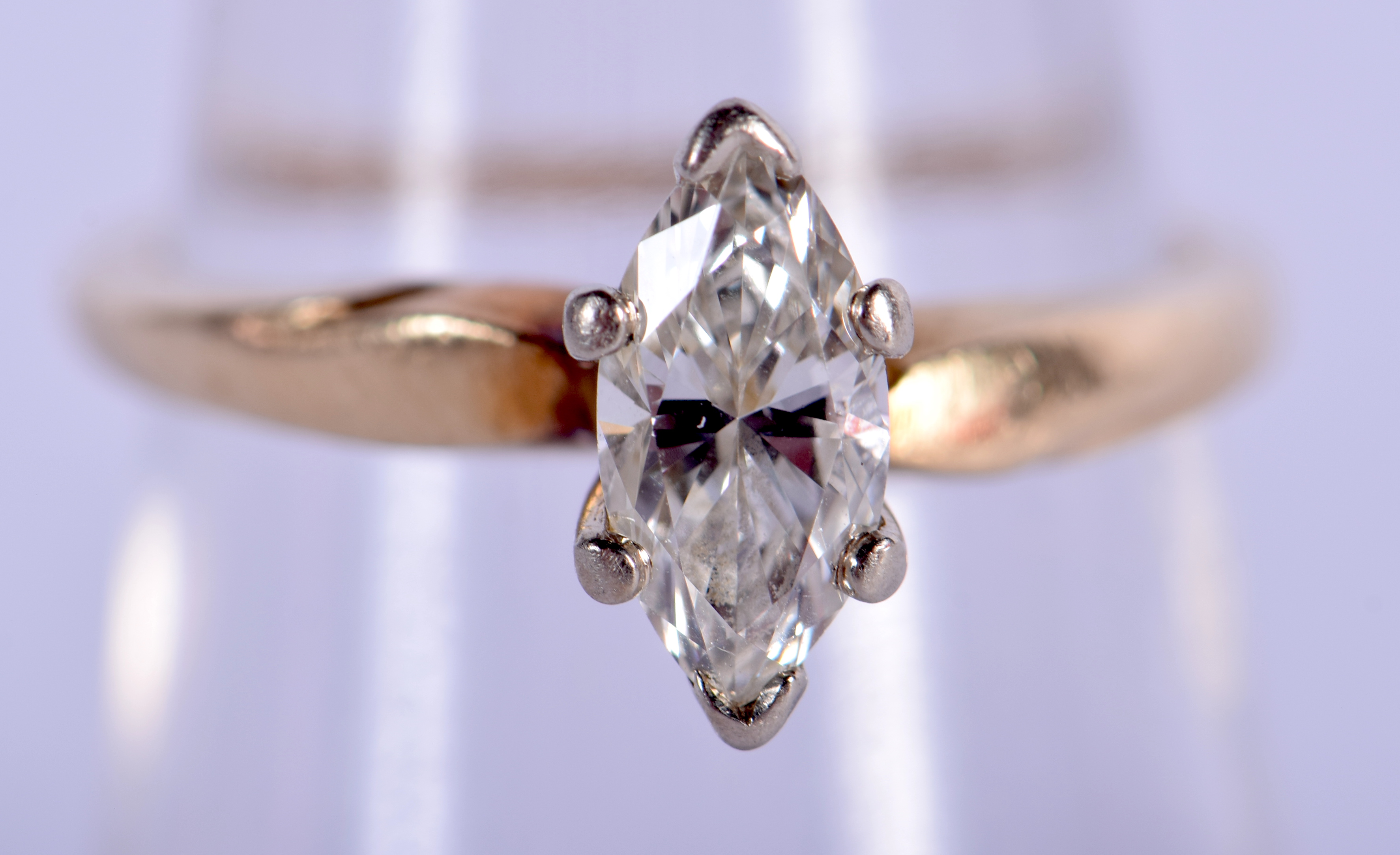 A 14CT GOLD MARQUISE CUT DIAMOND RING. M. 2.4 grams. Diamond 0.9 cm x 0.4 cm.