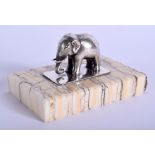 A CHARMING ANTIQUE SILVER AND MAMMOTH TOOTH ELEPHANT PAPERWEIGHT. 7 cm x 4.5 cm.