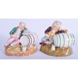 A RARE PAIR OF 19TH CENTURY ENGLISH PORCELAIN FIGURES modelled as two drunken males upon barrels. 8