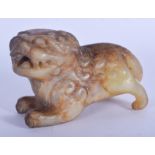 A CHINESE QING DYNASTY CARVED MUTTON JADE BUDDHISTIC LION modelled roaming and scowling. 9 cm x 6 cm