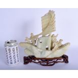 A LARGE EARLY 20TH CENTURY CHINSE CARVED JADE BOAT Late Qing, modelled with figures and a dog, upon