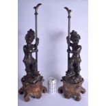 A LARGE PAIR OF 19TH CENTURY LACQUERED NUBIAN FIGURES modelled standing upon a scrolling acanthus ba