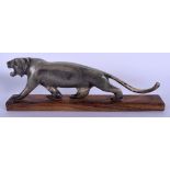A 19TH CENTURY MIDDLE EASTERN CARVED RHINOCEROS HORN TIGER upon a wooden plinth. Figure 20 cm wide.