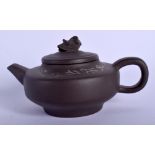 A CHINESE YIXING POTTERY TEAPOT AND COVER 20th Century, decorated with calligraphy. 11.5 cm wide.