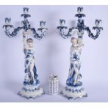 A LARGE PAIR OF ANTIQUE GERMAN BLUE AND WHITE PORCELAIN CANDELABRA painted with foliage. 61 cm x 18