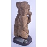 AN EARLY CONTINENTAL CARVED STONE FIGURE OF A MALE modelled holding his ear. Stone 20 cm x 8 cm.