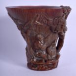 A CHINESE CARVED BUFFALO HORN TYPE LIBATION CUP decorated with figures within landscapes. 719 grams.