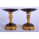 A PAIR OF 19TH CENTURY ORMOLU AND STEEL TAZZA decorated with motifs. 11 cm x 9 cm.