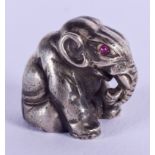 A CONTINENTAL SILVER FIGURE OF AN ELEPHANT with ruby eyes. 19 grams. 1 cm x 1 cm.