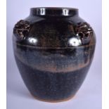 A CHINESE BROWN GLAZED STONE WARE JAR with mask head mounts. 24 cm x 16 cm.