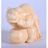 A 19TH CENTURY JAPANESE MEIJI PERIOD CARVED IVORY NETSUKE modelled as a boy wearing a theatrical clo