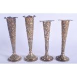 FOUR ANTIQUE MIDDLE EASTERN INDIAN SILVER VASES decorated with foliage. 918 grams loaded. Largest 18