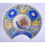 A 19TH CENTURY FRENCH FAIENCE POTTERY BARBERS SHAVING BOWL painted with birds. 23 cm wide.