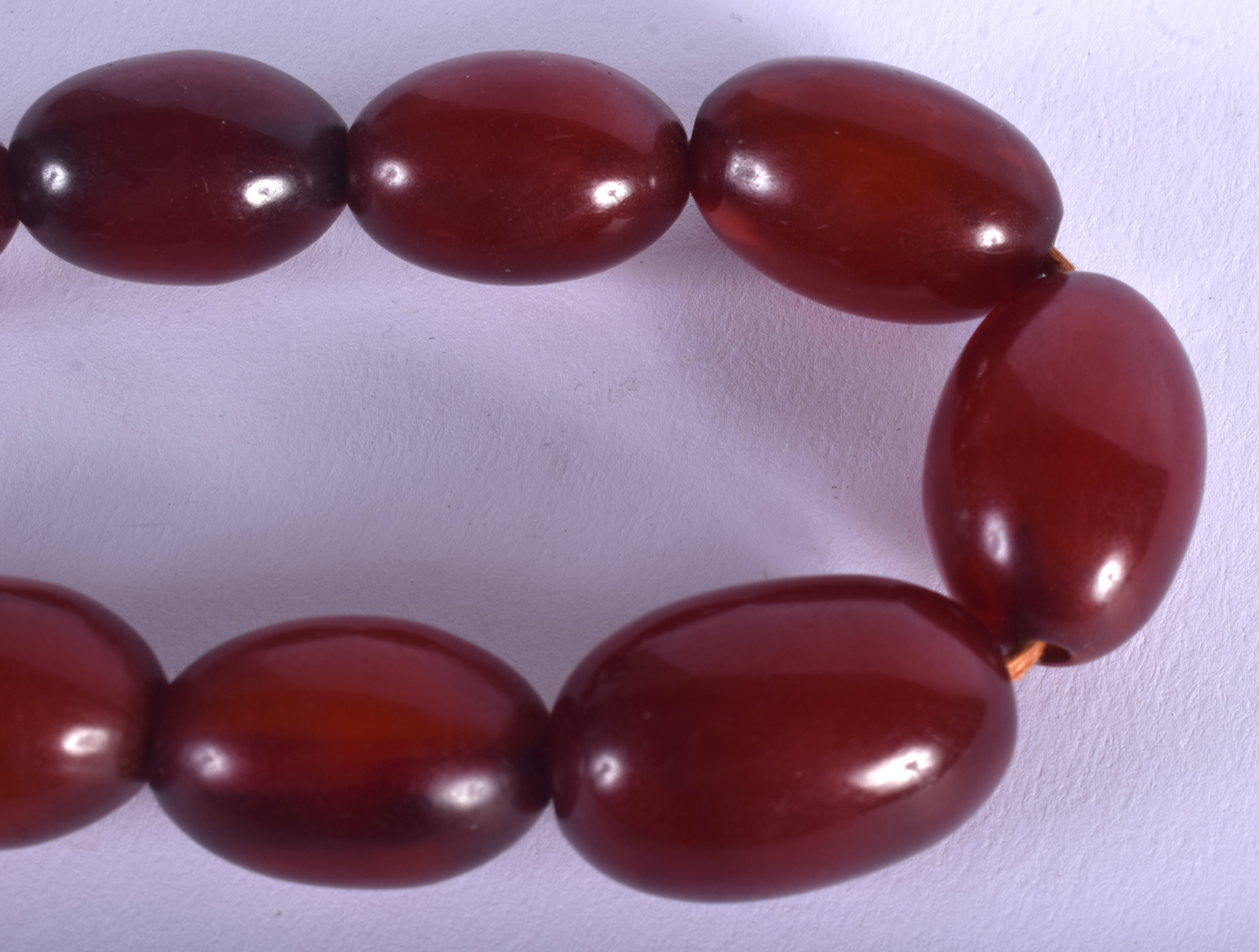 AN EARLY 20TH CENTURY CARVED RED AMBER BAKELITE TYPE NECKLACE of graduated form. 47 grams. 40 cm lon - Image 2 of 2