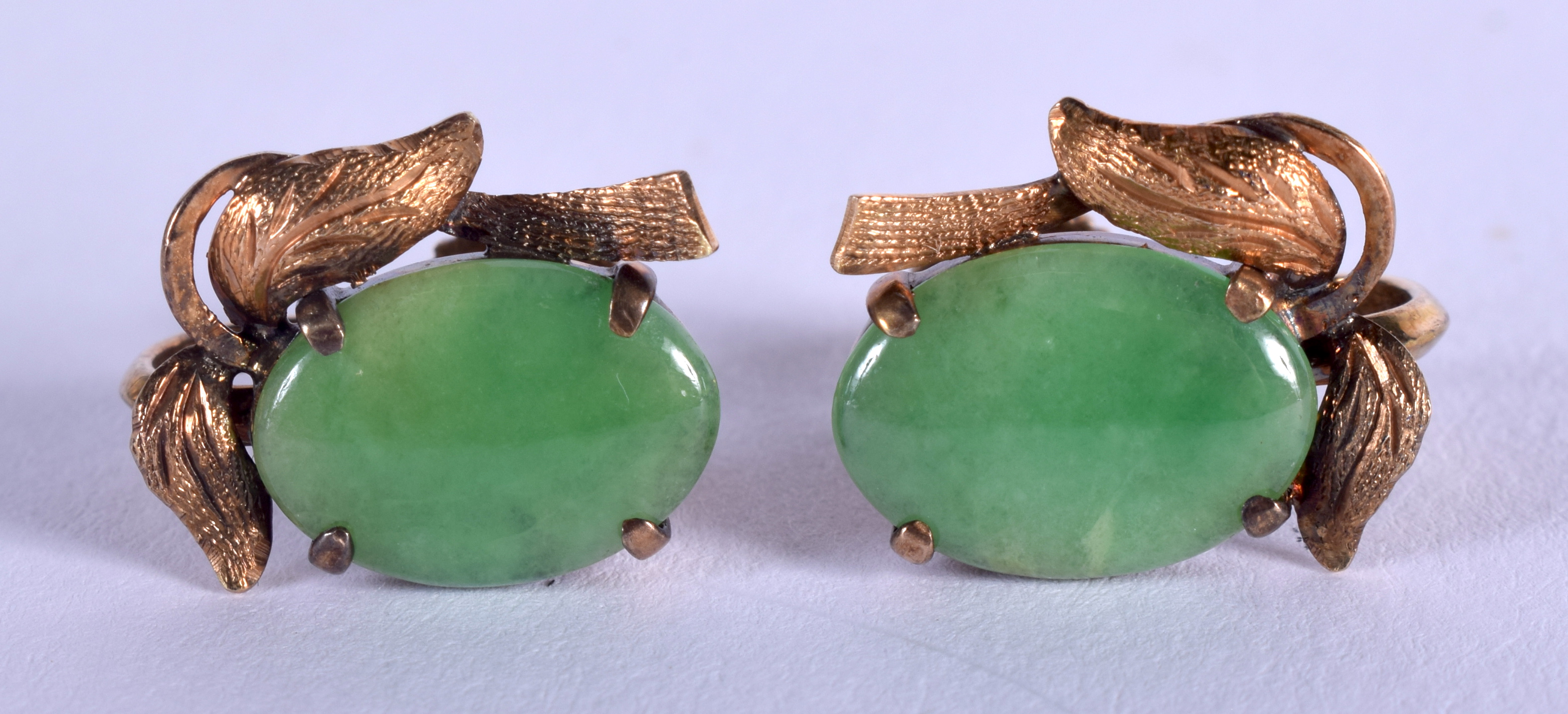 A PAIR OF 18CT GOLD MOUNTED JADEITE EARRINGS. 4 grams. Jadeite 1.5 cm x 1 cm.