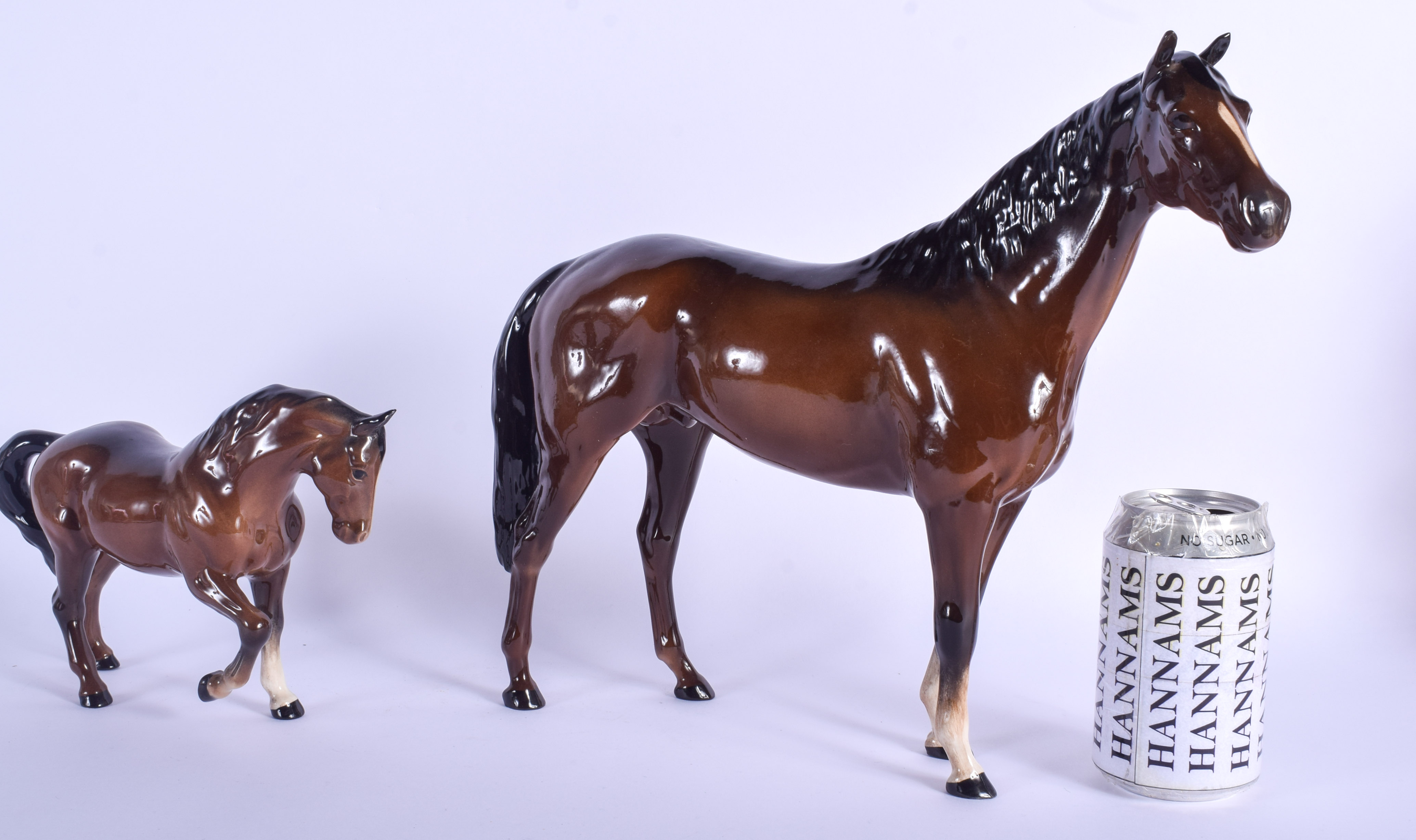 A RARE LARGE BESWICK PORCELAIN HORSE together with a smaller horse. Largest 33 cm x 30 cm. (2)