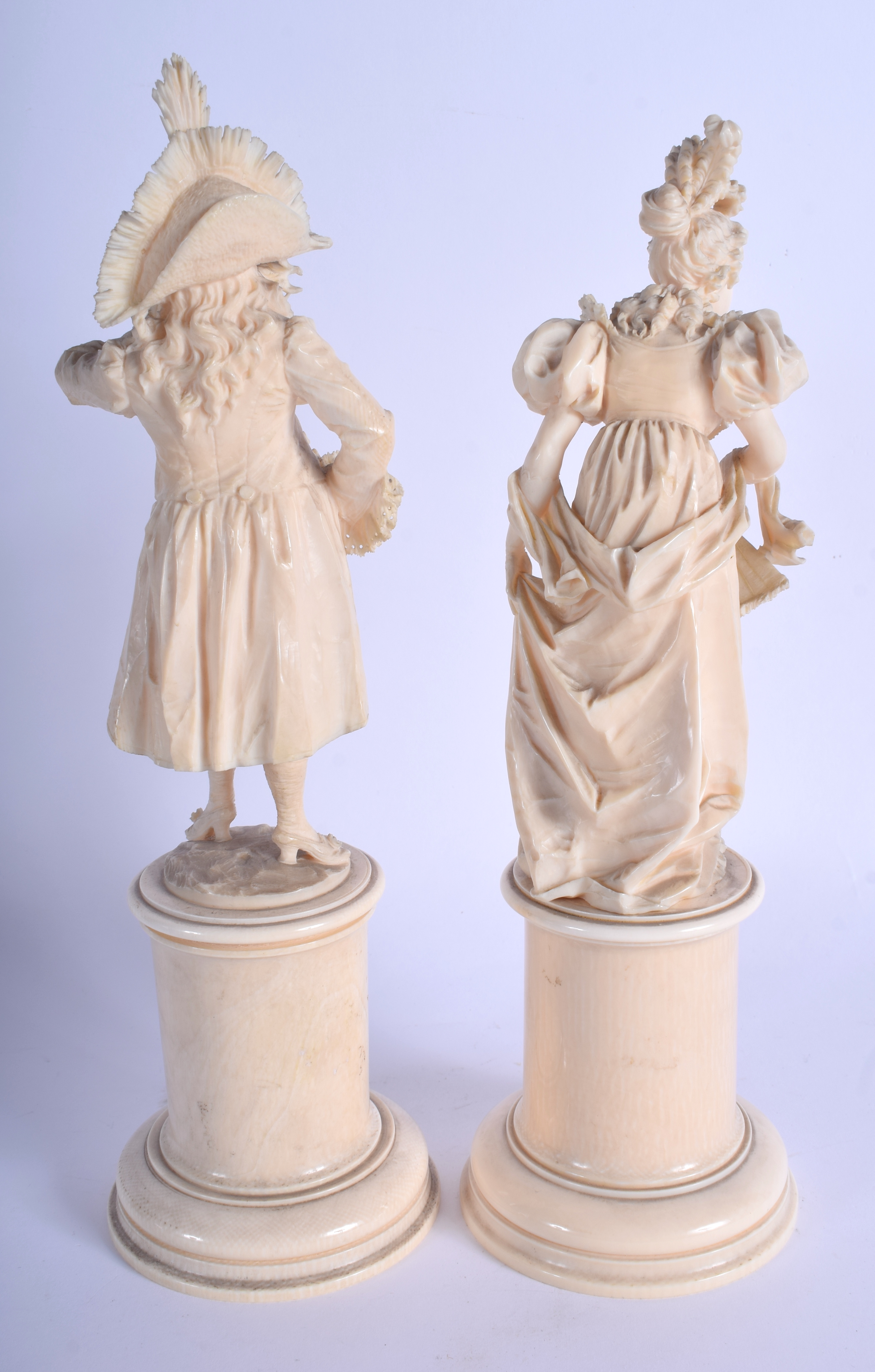 A PAIR OF 19TH CENTURY EUROPEAN CARVED DIEPPE IVORY FIGURES modelled as a dandy and female upon cyli - Image 2 of 5