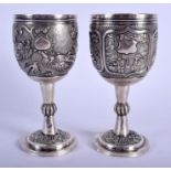 A FINE PAIR OF 19TH CENTURY CHINESE EXPORT SILVER GOBLETS by Wang Hing, decorated with dragons and f