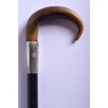 A 19TH CENTURY CONTINENTAL CARVED RHINOCEROS HORN HANDLED WALKING STICK. 89 cm long.