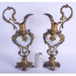 A LARGE PAIR OF 19TH CENTURY VASELINE GLASS EWERS mounted in French bronze. 47 cm x 16 cm.