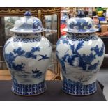 A LARGE PAIR OF CHINESE BLUE AND WHITE GINGER JARS AND COVERS 20th Century, painted with figures and