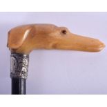 A 19TH CENTURY CARVED RHINOCEROS HORN DOG HEAD SWAGGER STICK with silver mounts. 81 cm long.