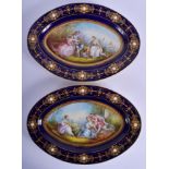 A LARGE PAIR OF 19TH CENTURY SEVRES PORCELAIN DISHES painted with lovers, jewelled in landscapes. 31