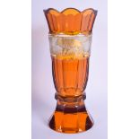 AN ANTIQUE BOHEMIAN AMBER GLASS FLUTED GOBLET VASE possibly Moser, decorated with a banding of lions
