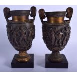 A PAIR OF 19TH CENTURY ITALIAN TWIN HANDLED BRONZE VASES After the Antiquity, decorated with classic