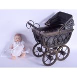 A VINTAGE FOLK ART TYPE CHILDS DOLLS PRAM containing a European bisque doll stamped W. Pram 24 cm x