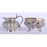 AN ANTIQUE INDIAN SILVER CREAM JUG and matching sugar basin. 182 grams. (2)