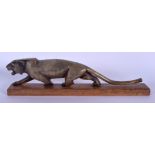 A 19TH CENTURY CONTINENTAL CARVED RHINOCEROS HORN FIGURE OF A ROAMING TIGER upon a wooden plinth. 25