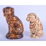 A 19TH CENTURY ENGLISH TREACLE GLAZED POTTERY SPANIEL MONEY BOX together with another similar. Large
